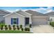 Charming single-story home with a well-manicured lawn and two-car garage in a sunny, vibrant neighborhood at 1120 Saguaro St, Haines City, FL 33844
