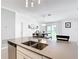 Bright kitchen with a center island, stainless steel dishwasher and a seamless view of the dining area at 1120 Saguaro St, Haines City, FL 33844