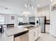 Open concept kitchen with stainless appliances, spacious island, and seamless flow to the living area at 1120 Saguaro St, Haines City, FL 33844
