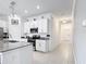 Clean kitchen featuring a center island, stainless appliances, and seamless flow to the entry hallway at 1120 Saguaro St, Haines City, FL 33844