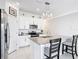 Bright kitchen showcasing stainless appliances, an island with seating, and plentiful white cabinets at 1120 Saguaro St, Haines City, FL 33844