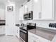 Well-appointed kitchen featuring stainless steel appliances, ample cabinet space, and stylish countertops at 1120 Saguaro St, Haines City, FL 33844