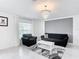 Cozy living room with elegant chandelier, neutral color palette, and comfortable seating at 1120 Saguaro St, Haines City, FL 33844
