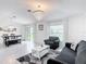 Open-concept living area with dining and seating featuring abundant natural light and modern decor at 1120 Saguaro St, Haines City, FL 33844