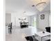 Open floor plan seamlessly connecting the dining area to the living room with neutral color schemes at 1120 Saguaro St, Haines City, FL 33844