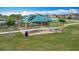 Community picnic area featuring shaded tables and a trash receptacle set amidst a spacious lawn, perfect for outdoor gatherings at 1120 Saguaro St, Haines City, FL 33844