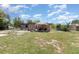 Cozy backyard featuring a charming patio area with seating and a large grassy space, perfect for outdoor relaxation at 11509 Cameron St, Orlando, FL 32817