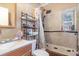 Bathroom with a shower/tub, toilet, and vanity, along with shelving unit for storage at 11509 Cameron St, Orlando, FL 32817
