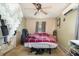 Bedroom with a ceiling fan, window, and a bed with a red plaid blanket in the home at 11509 Cameron St, Orlando, FL 32817
