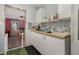 Bright kitchen with white cabinets and stainless steel appliances adjacent to the dining room at 11509 Cameron St, Orlando, FL 32817