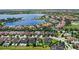 Expansive aerial view of a residential area with homes, pools, and a large lake at 11707 Hampstead St, Windermere, FL 34786