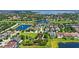 Panoramic aerial view of a residential community, showcasing lush landscaping and a tranquil lake at 11707 Hampstead St, Windermere, FL 34786