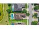 Aerial of a home's backyard pool, tiled roof, and green lawn in a quiet residential neighborhood at 11707 Hampstead St, Windermere, FL 34786
