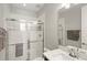 Modern bathroom featuring glass enclosed shower, tiled walls, and sleek vanity at 11707 Hampstead St, Windermere, FL 34786