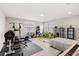 Spacious room featuring exercise equipment, a desk and shelving unit, offering space for fitness and hobbies at 11707 Hampstead St, Windermere, FL 34786