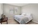 Cozy bedroom featuring a comfortable bed, natural light, and a small desk area at 11707 Hampstead St, Windermere, FL 34786