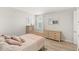 Comfortable bedroom with a soft pink theme, wood floors, and neutral walls at 11707 Hampstead St, Windermere, FL 34786