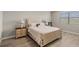 Cozy bedroom with a large bed, wood floors, and a window offering natural light and a serene atmosphere at 11707 Hampstead St, Windermere, FL 34786