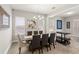 Elegant dining room with modern chandelier, and seating for six at 11707 Hampstead St, Windermere, FL 34786