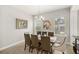 Modern dining room with a large wooden table, comfortable chairs, and natural light at 11707 Hampstead St, Windermere, FL 34786