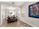 Bright dining room featuring a wine cart, large windows, and modern art at 11707 Hampstead St, Windermere, FL 34786