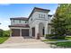 Elegant two-story home with a tiled roof, arched entryway, and manicured landscaping, showcasing curb appeal at 11707 Hampstead St, Windermere, FL 34786