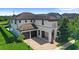 Elegant two-story home with a tile roof, arched entry, two-car garage, and beautifully landscaped front yard at 11707 Hampstead St, Windermere, FL 34786