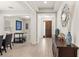 Elegant foyer with hardwood floors, decorative mirror, console table, and an open view to the dining and living areas at 11707 Hampstead St, Windermere, FL 34786