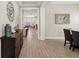 Open-concept foyer with hardwood floors leading to the dining and living areas, showcasing an inviting and airy layout at 11707 Hampstead St, Windermere, FL 34786