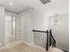Hallway with wood floors and a black iron stair railing, offering a view to the rooms and stairs at 11707 Hampstead St, Windermere, FL 34786