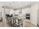 Modern kitchen with a center island, white cabinets, granite countertops, stainless steel appliances, and pendant lighting at 11707 Hampstead St, Windermere, FL 34786