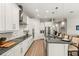 Bright kitchen with white cabinets, granite countertops, stainless steel appliances and a center island with barstool seating at 11707 Hampstead St, Windermere, FL 34786