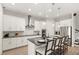 Modern kitchen featuring white cabinets, granite countertops, stainless steel appliances and a center island with seating at 11707 Hampstead St, Windermere, FL 34786