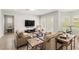Relaxing living room featuring neutral decor, comfortable seating, and patio access at 11707 Hampstead St, Windermere, FL 34786