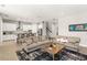 Cozy living room with stylish sofas, wood floors, and an open layout into the kitchen at 11707 Hampstead St, Windermere, FL 34786