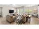 Comfortable living room with two sofas, dark wood tables, and large windows at 11707 Hampstead St, Windermere, FL 34786