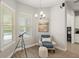 Inviting sitting area with a cozy chair, telescope, and natural light at 11707 Hampstead St, Windermere, FL 34786