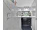Elegant bathroom features a sleek black vanity, bright mirror, and marble-look tile walls at 1216 Floral Way, Apopka, FL 32703