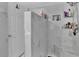 Luxurious shower with marble-patterned walls and a built-in niche for toiletries at 1216 Floral Way, Apopka, FL 32703
