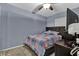 Cozy bedroom featuring a comfy bed with a colorful quilt and a ceiling fan at 1216 Floral Way, Apopka, FL 32703