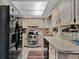Functional kitchen with stainless steel appliances, white cabinets, and tiled backsplash at 1216 Floral Way, Apopka, FL 32703