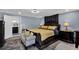 Bright bedroom with a cozy sitting area, adjacent to a private bathroom with a dark vanity at 1216 Floral Way, Apopka, FL 32703