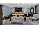Relaxing bedroom featuring a king bed, plush seating, and elegant lighting fixtures at 1216 Floral Way, Apopka, FL 32703