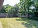 A secluded backyard featuring a wood fence and mature tropical landscaping at 1229 Deneece Ter, Daytona Beach, FL 32117