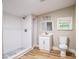 This bathroom has wood floors, a vanity, and a shower at 1229 Deneece Ter, Daytona Beach, FL 32117