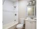 Bright bathroom featuring a tiled shower and tub combination, along with a vanity at 1229 Deneece Ter, Daytona Beach, FL 32117