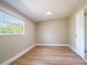 Neutral bedroom filled with light and a modern wood-look floor at 1229 Deneece Ter, Daytona Beach, FL 32117