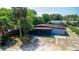A low angle view of a charming single-story home with a porch, complemented by mature trees at 1229 Deneece Ter, Daytona Beach, FL 32117