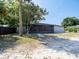 Charming single-story home with a screened-in porch and mature landscaping at 1229 Deneece Ter, Daytona Beach, FL 32117