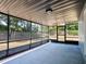 Enclosed patio with concrete flooring and views of the landscaped backyard at 1229 Deneece Ter, Daytona Beach, FL 32117